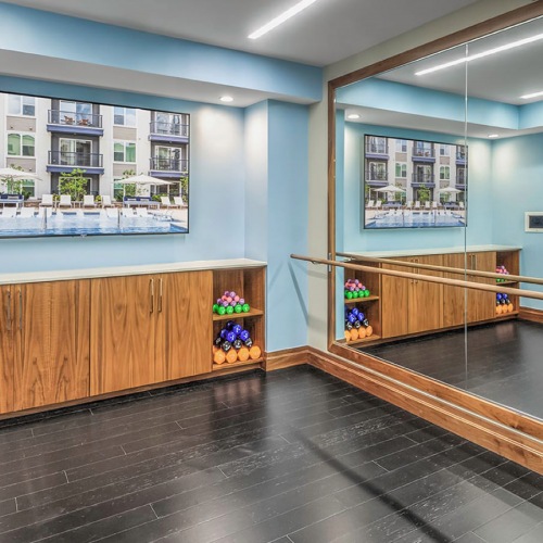 Maddox South End Fitness Center Yoga studio with bar and weights