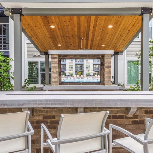 Maddox South End Common Space Well-kept outdoor hangout space with seating and shade